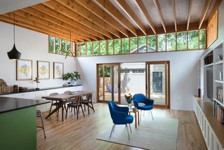 Bringing Light Into a Modest 1940s Bungalow in Austin - Photo 6 of 10 - No.1 Douglas Fir adds warmth to the space. Custom clerestory lighting that wraps the interior allows light to fall deeper into the room. Large, sliding glass doors connect the interiors to the outdoor deck.