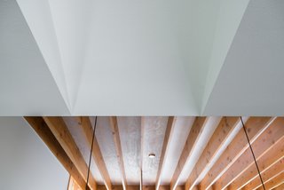 Bringing Light Into a Modest 1940s Bungalow in Austin - Photo 10 of 10 - The plywood roof deck is left exposed as the finished ceiling product. A pickling stain has been adhered to lighten the tone and subdue the grain pattern, thus providing a reflective surface and a warm, natural element.