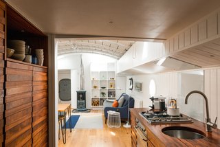 A Saikai Kaico Japanese enamel kettle and hand thrown dishes by David Green Ceramics sit proudly in the galley kitchen. 