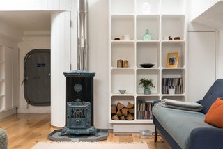 An original 1920s Goodin Woodburning Stove anchors the cozy living space. 