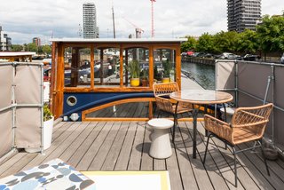 A round concrete stool, table and chairs, custom cushions, and outdoor rug create the perfect terrace setting to look out to the city beyond. 