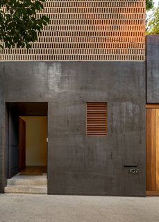 Delightful Material Contrasts Define a Courtyard Home in Mexico City - Photo 1 of 10 - The black finish on the exterior facade is a modern interpretation of Corey, the artisan stucco used in traditional Mexican cities.