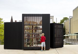 Toronto's Story Pod Doubles as a Lending Library and Community Hub - Photo 2 of 7 - Widely spaced vertical wood slats anchor attention to the stacks of books arranged on the interior.