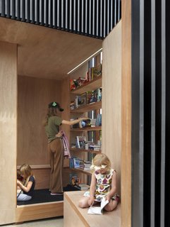 Toronto's Story Pod Doubles as a Lending Library and Community Hub - Photo 5 of 7 - Wrapped in marine grade veneer plywood, the interior walls frame a warm oasis for reading and viewing.