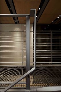 Simple, modern details frame the catwalks and stairways that connect the spaces vertically and laterally. A grated walk allows light to penetrate further into the space. 