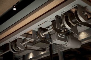 Gears allow the large, mechanical door to open with the turn of a crank. 