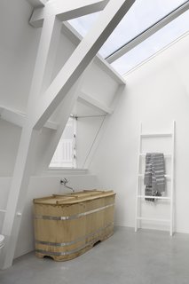 A traditional Japanese-style bathtub, custom-ordered through Bartok Design, sits elegantly in one of the baths.