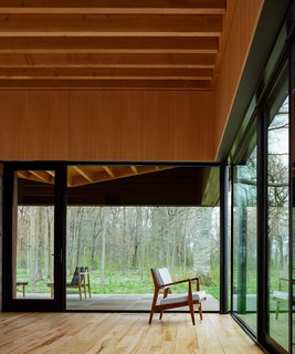 A Dramatic Cantilevered Roof Creates a Spacious Terrace Overlooking Lake Michigan - Photo 5 of 11 - Large sliding glass doors create seamless indoor/outdoor living.