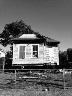 An exterior photograph shows the home at its original location prior to relocation and renovation.