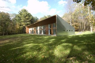 The cedar-wrapped deck appears be carved out of the metal-wrapped shape. 