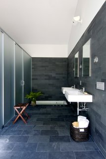 Natural materials connect the master bath with the setting. A sunken tub within the floor provides the perfect retreat. 