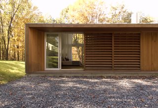 Wooden screens provide privacy to the master bedroom from the entrance facade. 