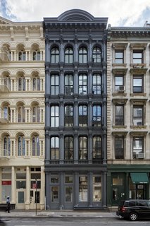 A Hidden Penthouse Sits Atop a Historic Cast-Iron Building in New York - Photo 3 of 16 - Earning the nickname "The Obsidian Building," the charcoal gray facade conceals the penthouse and modern renovations from the street level. 