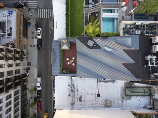 A Hidden Penthouse Sits Atop a Historic Cast-Iron Building in New York - Photo 16 of 16 - The secluded terrace is hidden behind the building's pediment. 