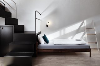 A Stylish Hostel in a Historic Czech Fortress Starts at $16 a Night - Photo 6 of 19 - Modern, bent metal stair treads and risers lead to the upper sleeping quarters.