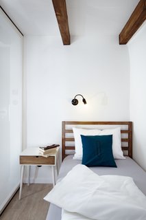 A Stylish Hostel in a Historic Czech Fortress Starts at $16 a Night - Photo 16 of 19 - Wooden beams, wood floors, and wood furniture pieces introduce raw elements and textures. 