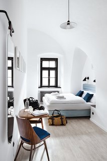 A Stylish Hostel in a Historic Czech Fortress Starts at $16 a Night - Photo 2 of 19 - Private rooms provide lush, comfortable accommodations with arched ceilings and light-filled interiors. 