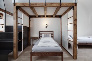 A Stylish Hostel in a Historic Czech Fortress Starts at $16 a Night - Photo 17 of 19 - Wood framing and bent metal stairs create a uniquely formed mezzanine and sleeping area with modern detailing. 