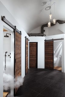 A Stylish Hostel in a Historic Czech Fortress Starts at $16 a Night - Photo 9 of 19 - Sliding wood barn doors conceal shower rooms. 