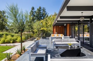 An Award-Winning Midcentury Residence in Los Angeles County Asks $3.9M - Photo 3 of 17 - Exterior overhangs provide shading for exterior seating, while also protecting the interior from the warm, summer sun. 
