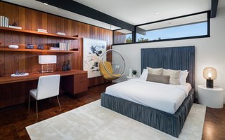 An Award-Winning Midcentury Residence in Los Angeles County Asks $3.9M - Photo 8 of 17 - Custom built-ins provide an office space and storage in a guest bedroom. A hanging midcentury modern orb chair adds a touch of retro flair. 