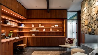An Award-Winning Midcentury Residence in Los Angeles County Asks $3.9M - Photo 10 of 17 - Custom L-shaped, open shelving provides ample storage in the office. 