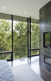 The master suite is filled with plentiful views, while taking advantage of the outside forest for complete privacy year-round. 