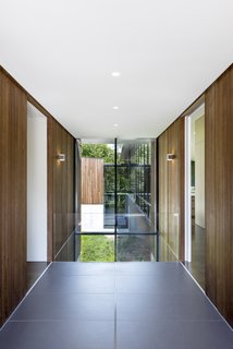 Large format Fiandre floor tiles fill the entry sequence and align with the building module. 