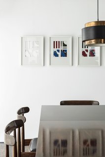 Artwork by Jean-Pierre Murray accents the dining space furnished with Alfred Hendrickx table and chairs. 