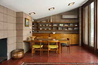The dining table is original to the house. A glass top now sits on top to preserve the surface from further wear and tear. H.W. Klein #250 dining chairs manufactured by Bramin complement the table. 