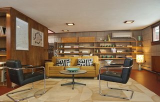 The family room is filled with midcentury furnishings and accessories. Bauhaus chairs, a Danish design credenza from the owner's vintage collection, a wood fire stove, a record player, and shelves of books create a comfortable space for hanging out. 