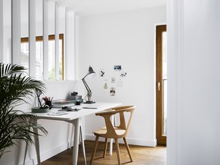 A Sleek Renovation in London Ushers Light Into a Family Home - Photo 3 of 11 - An IKEA desk and wooden chair provide working accommodations in the study, overlooking the main living space. 