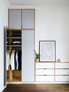 A Sleek Renovation in London Ushers Light Into a Family Home - Photo 8 of 11 - Wardrobe closets display the exposed ply edges, which create a unique outline within the millwork. 