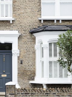 A Sleek Renovation in London Ushers Light Into a Family Home - Photo 1 of 11 - The renovated home maintains some of the original character. From the front elevation, the contemporary refurbishments are concealed.