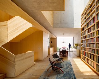 Oscar Hagerman chairs and a Saarinen side table flank the bookshelf in the reading area. 