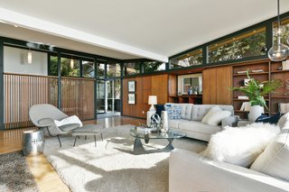 Continuous clerestory windows provide views out into the surroundings from all edges. The butterfly roof appears to hover atop the structure. 