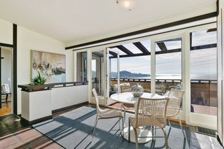 Full-height glass doors allow the viewing terrace to blend seamlessly into the interior breakfast nook.