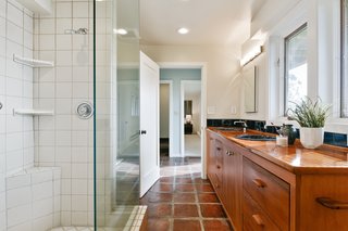 A full bath with a double vanity and walk-in shower is accessible from both bedrooms on the lower level.