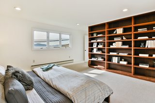 Built-in bookshelves frame the master bedroom. 