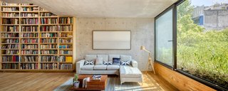 A subtle piece of artwork composed of graphite and ink on paper, created by Luis Felipe Ortega, hangs above the sofa in the living room. A custom coffee table created by Tapia McMahon sits at the foot of the sofa. 