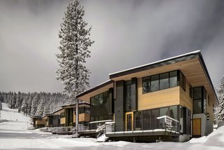 These Contemporary Lake Tahoe Chalets Have Ski-In, Ski-Out Access - Photo 2 of 11 - Western red cedar siding wraps the exterior of the townhomes as they step down the ski slope. Anderson E-windows frame views of the mountainside. 
