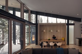 These Contemporary Lake Tahoe Chalets Have Ski-In, Ski-Out Access - Photo 7 of 11 - A wood-framed banquette punctuates the dining space. Herman Miller Eames Shell Chairs and Alvar Aalto Pendants decorate the eating area. 