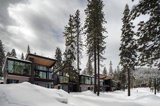 These Contemporary Lake Tahoe Chalets Have Ski-In, Ski-Out Access - Photo 9 of 11 - Western red cedar, stained black, gray, and natural, wrap the facades of the residences. Roof canopies reach outwards to engage with the homes' setting. Windows by Sierra Pacific provide incredible views of the surroundings. 