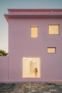 Large windows connect occupants to the exterior courtyard and surroundings.