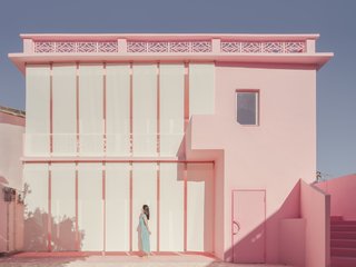 Curtains wrap Her House like a veil, creating a feminine solution for a new facade.