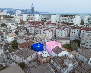 His and Her House stand in startling contrast to the muted tones of the surrounding village. They represent a spirit of innovation, architectural expressionism, and an advancement in urbanization.