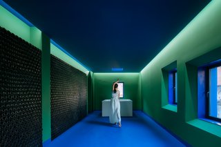 In the main interior space of His House, a whole wall is decorated with empty beer bottles, revealing a theme of "Wine, Pool, Meat, Forest."