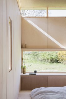 A long window frames panoramic views of the setting beyond.