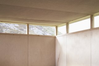 Continuous windows draw daylight deep into the space, while providing views of the distant landscape and sky beyond.