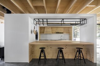 A customized wine glass and pot holder hangs above the island.
